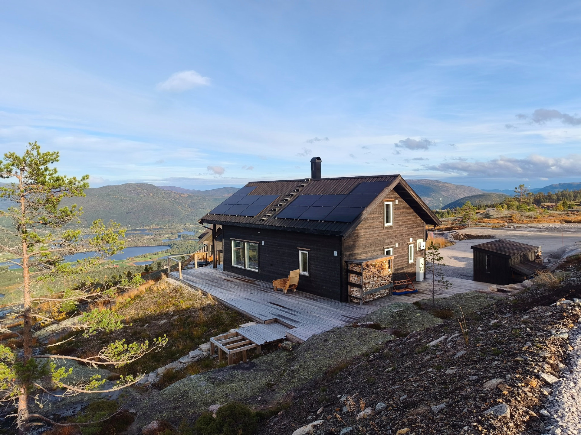 Mountain cabin on a rocky ridge above the lake
